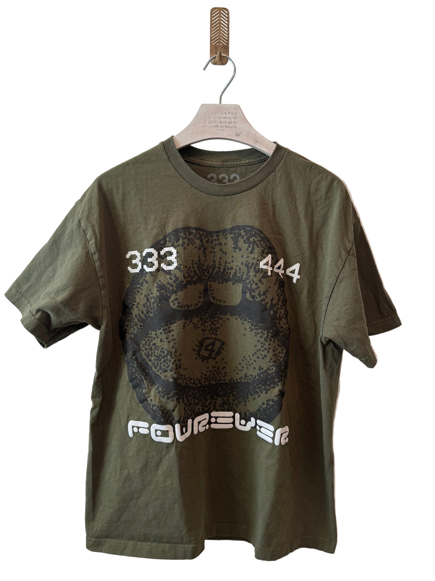 Green t-shirt with graphic design on a white background