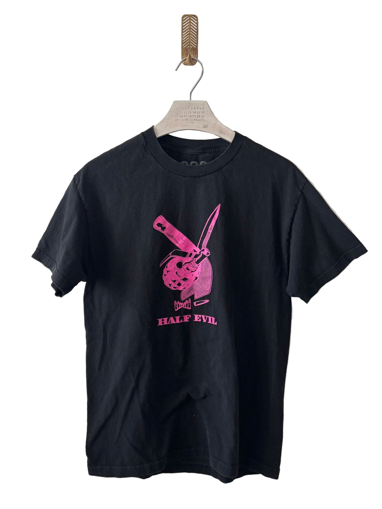 Black t-shirt with pink graphic design on a white background
