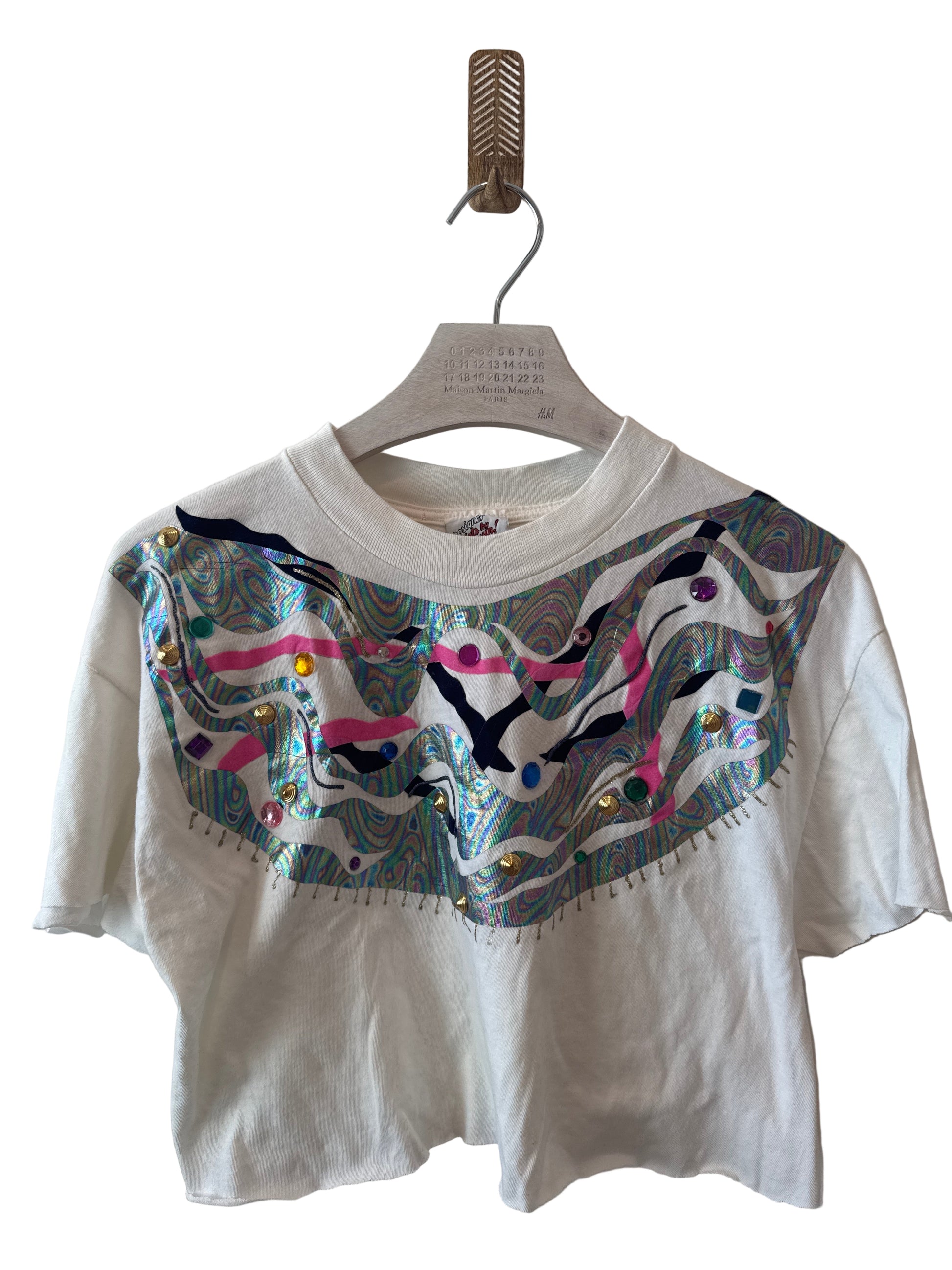 White t-shirt with colorful graphic design on a white background